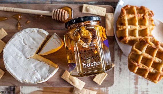 A selection of honey-based products displayed on a wooden table