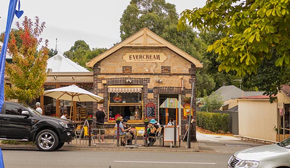 A heritage brick building selling ice cream with diners at the front