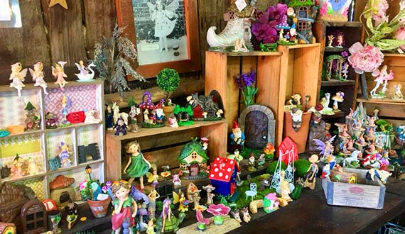 A selection of toys and models displayed on a wooden bench