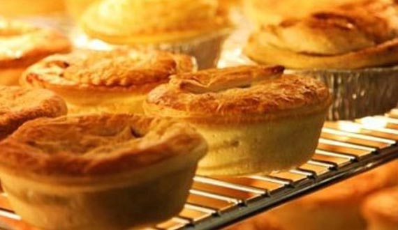 A number of pies displayed on a wire rack