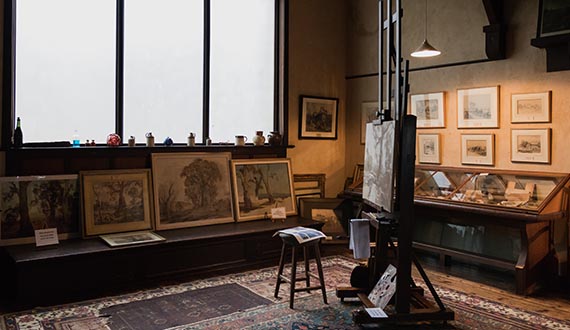 A painter's studio, lined with watercolours and heritage-style furnishings