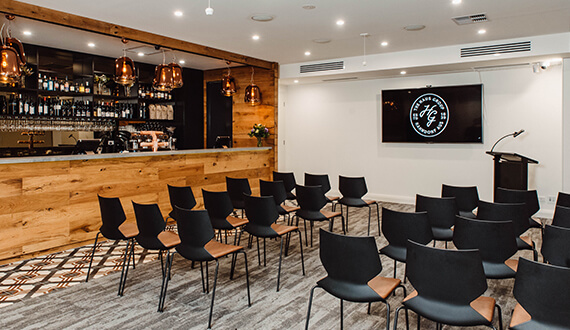 A conference set up in a modern venue with rustic wooden furnishings