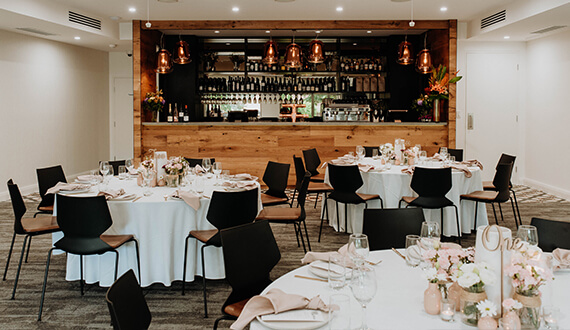 A conference set up in a modern venue with rustic wooden furnishings