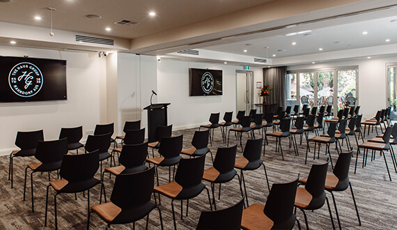 A conference set up in a modern venue with rustic wooden furnishings