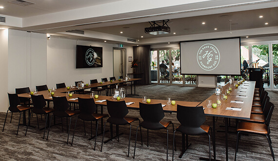 A conference set up in a modern venue with rustic wooden furnishings