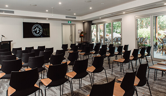 A conference set up in a modern venue with rustic wooden furnishings