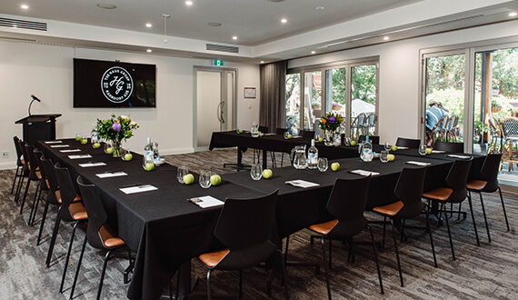 A conference set up in a modern venue with rustic wooden furnishings